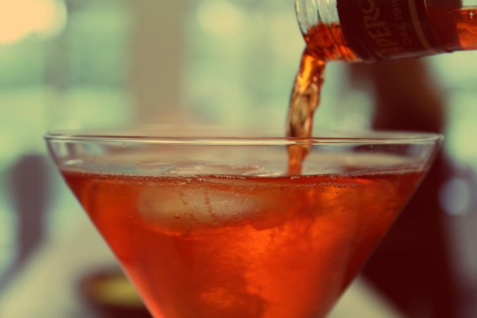 A cocktail being finished at the bar