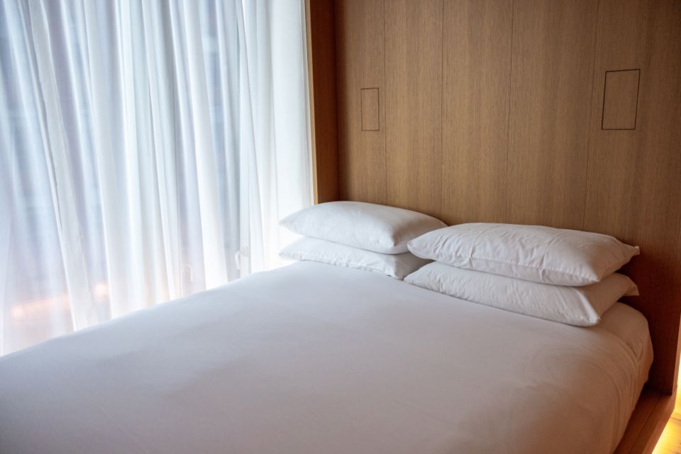 A guest room with a large bed and soft lighting