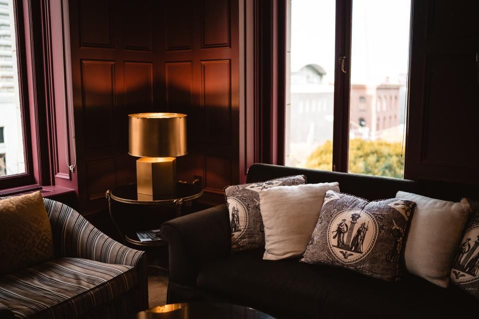 A suite sitting room with a sofa and armchairs